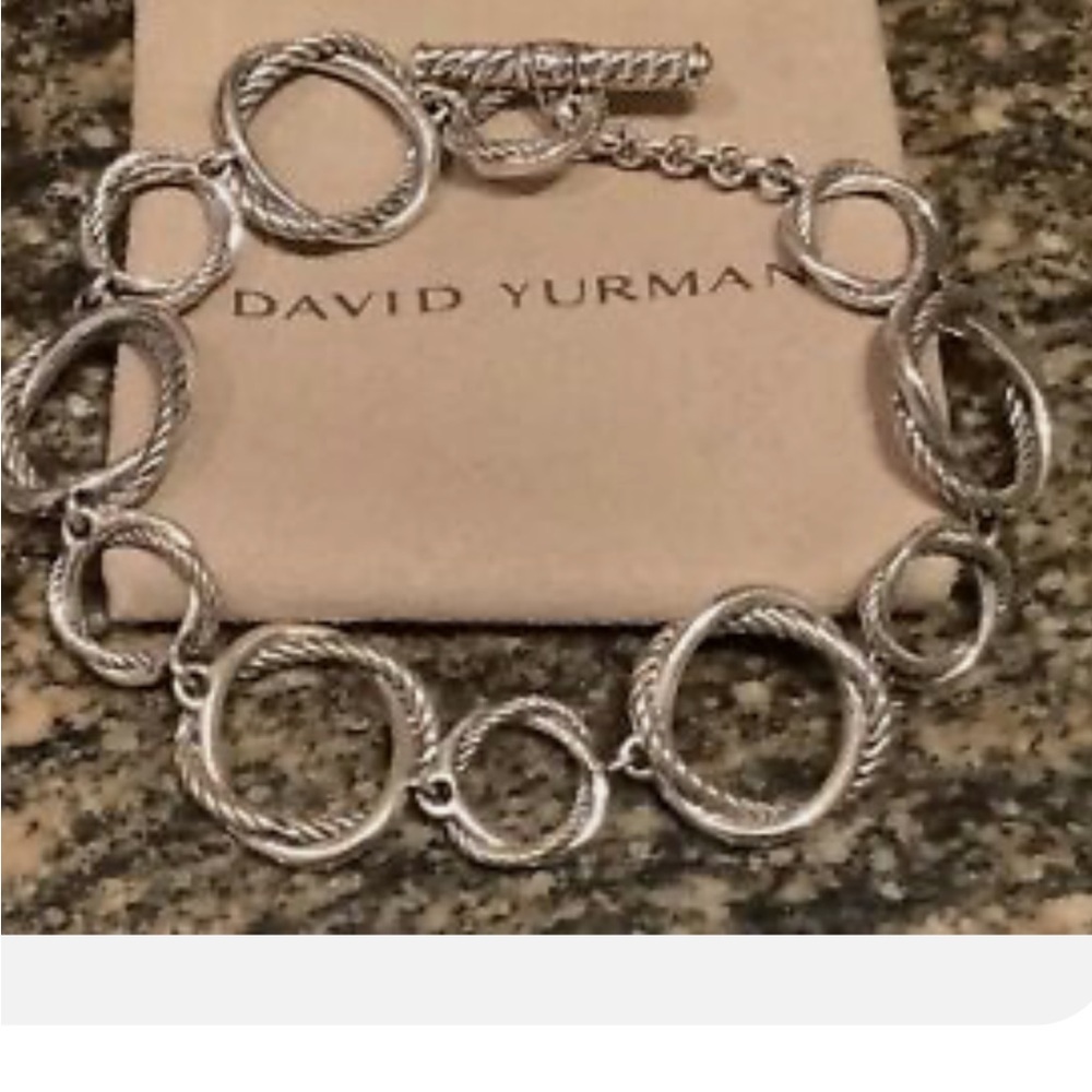 David Yurman, 7” silver infinity link bracelet.